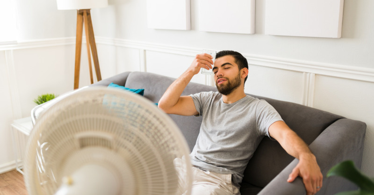 A person cooling down in front of a fan, illustrating how hyperhidrosis symptoms can change over time